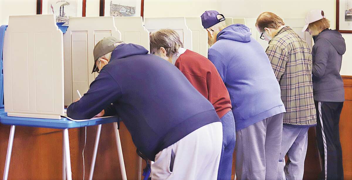 John Badman|The Telegraph Voters in Alton Precinct 1, located at Alton City Hall, line up to cast ballots on Nov. 8. The spring election with municipal and school board contests will be held April 4.