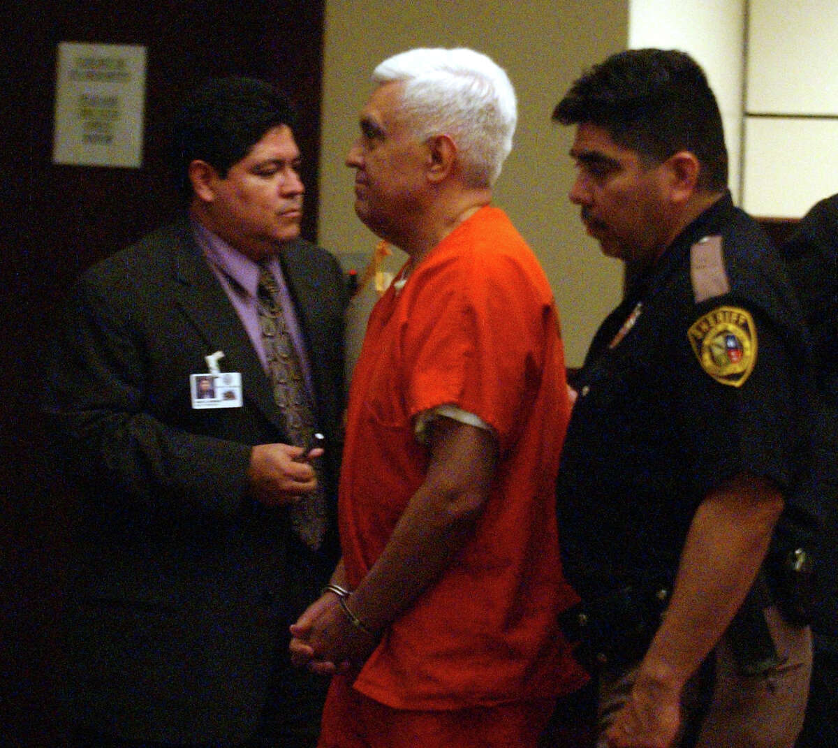 Former Councilman Raul Prado is led away after receiving a four-year prison term for his role in a public corruption scandal. He pleaded guilty to bribery charges and was sentenced in 2004. 