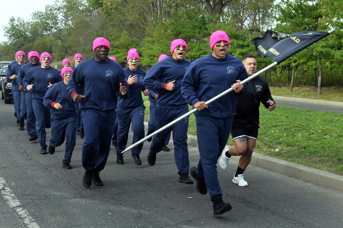 Recruits of the Bridgeport Police Academy run in Seaside Park prior to a fitness competition with recruits from the Bridgeport Fire Department, in Bridgeport, Conn. Sept. 30, 2022.