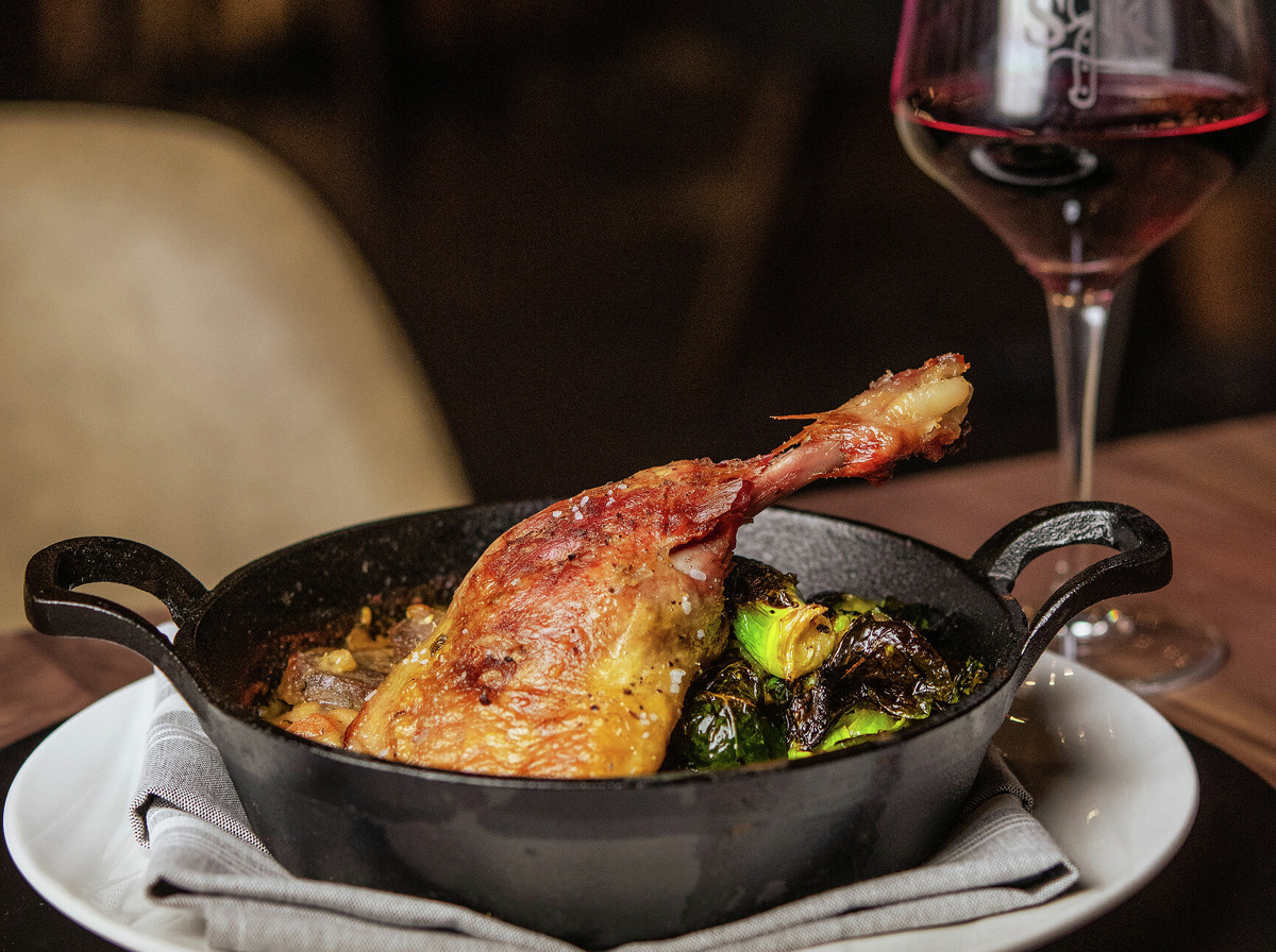 Duck cassoulet is served in a cast-iron pan at the new Scarlet Knife restaurant in Latham.