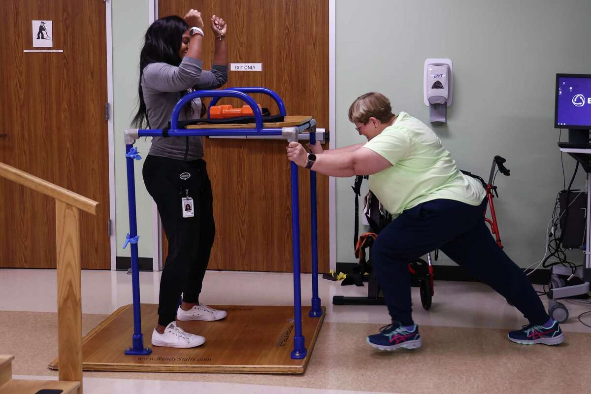 Breast cancer patient Twana Krauhs undergoes physical therapy with her trainer Lynley Moses at TIRR Outpatient Rehab Facility in Sugar Land, TX; Friday, November 11, 2022.