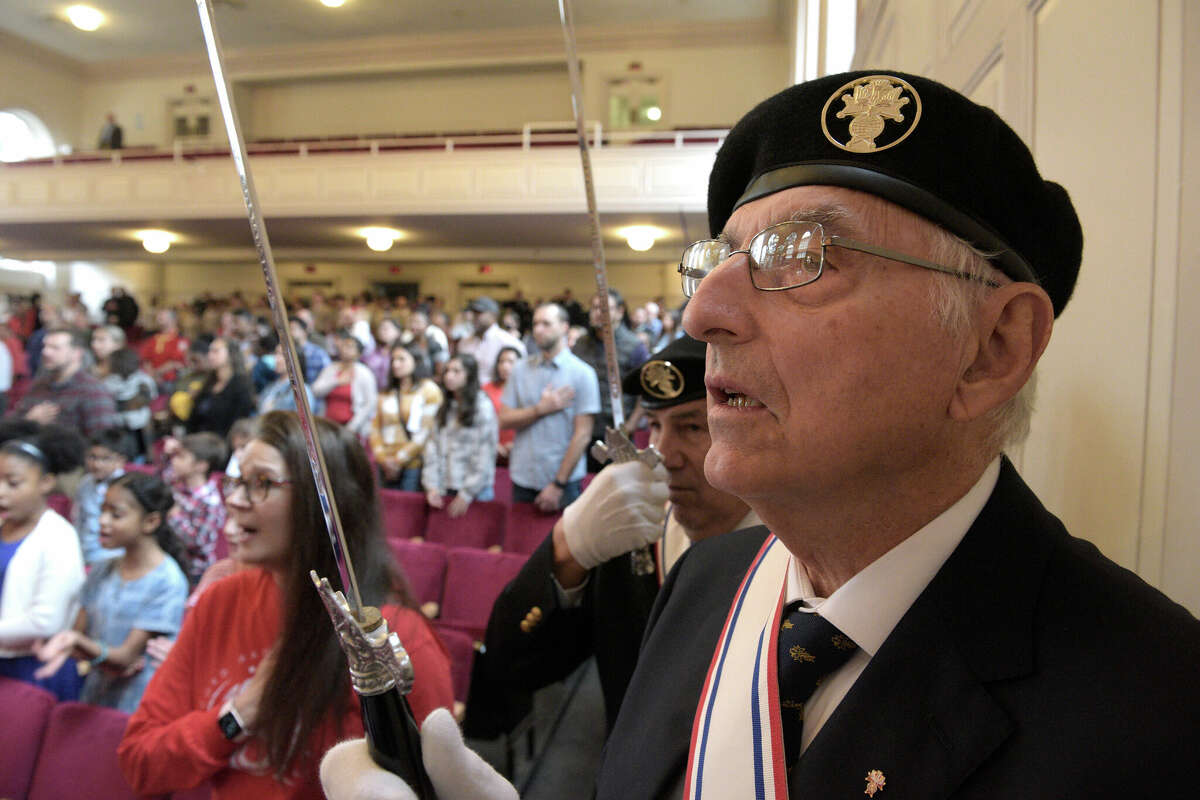 Bramwell Wood, of Norwalk, a member of the Knights of Columbus assembly 100, which lead the Norwalk Police Department Color Guard to the stage, sings the National Anthem during the City of Norwalk Veterans Day Commemoration, held at City Hall, Friday, November 11, 2022, Norwalk, Conn.