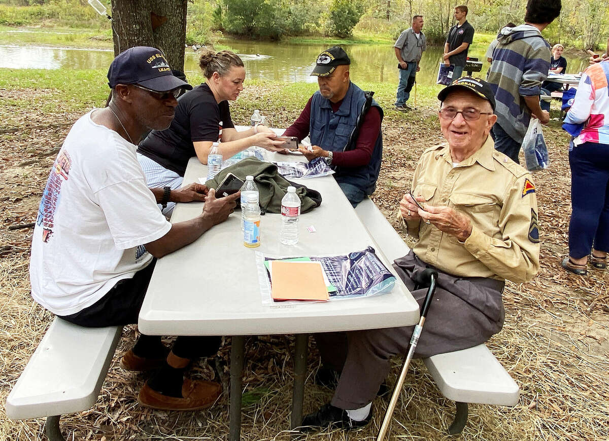 Korean Vet Raymond Donato on the right in the khaki shirt is 94-years-old was a guest at the Veteran's Day celebration at Langetree Eco Center and Tiny Home Community.