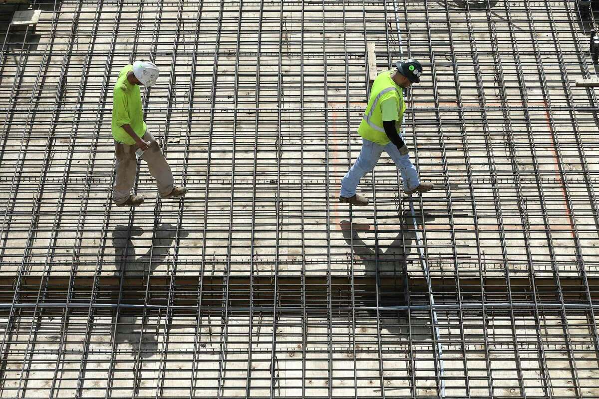 Workers lay rebar for concrete at a construction site at San Antonio College.