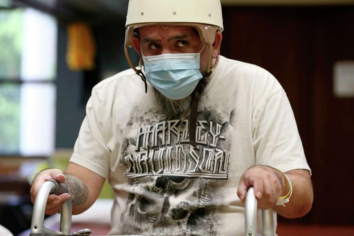 Joe Angel Garcia, 43, takes a break during rehab at Warm Springs Rehabilitation Hospital. Garcia suffered severe brain, spinal and other injuries after a drunken driver drove a three-ton Lincoln Navigator into his motorcycle on Sept. 19, 2021. “The after-effects of it are catastrophic,” said his wife, Elizabeth Guajardo. “He’s not the same Joe and never will be.”