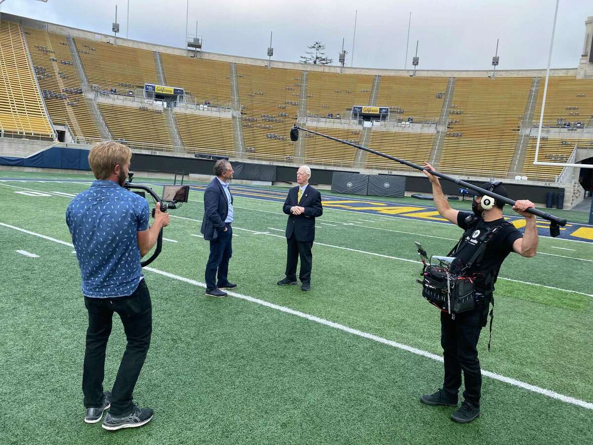 Jeremy Schaap (second from left) interviews Cal broadcaster Joe Starkey for the documentary “The Band is on the Field.”