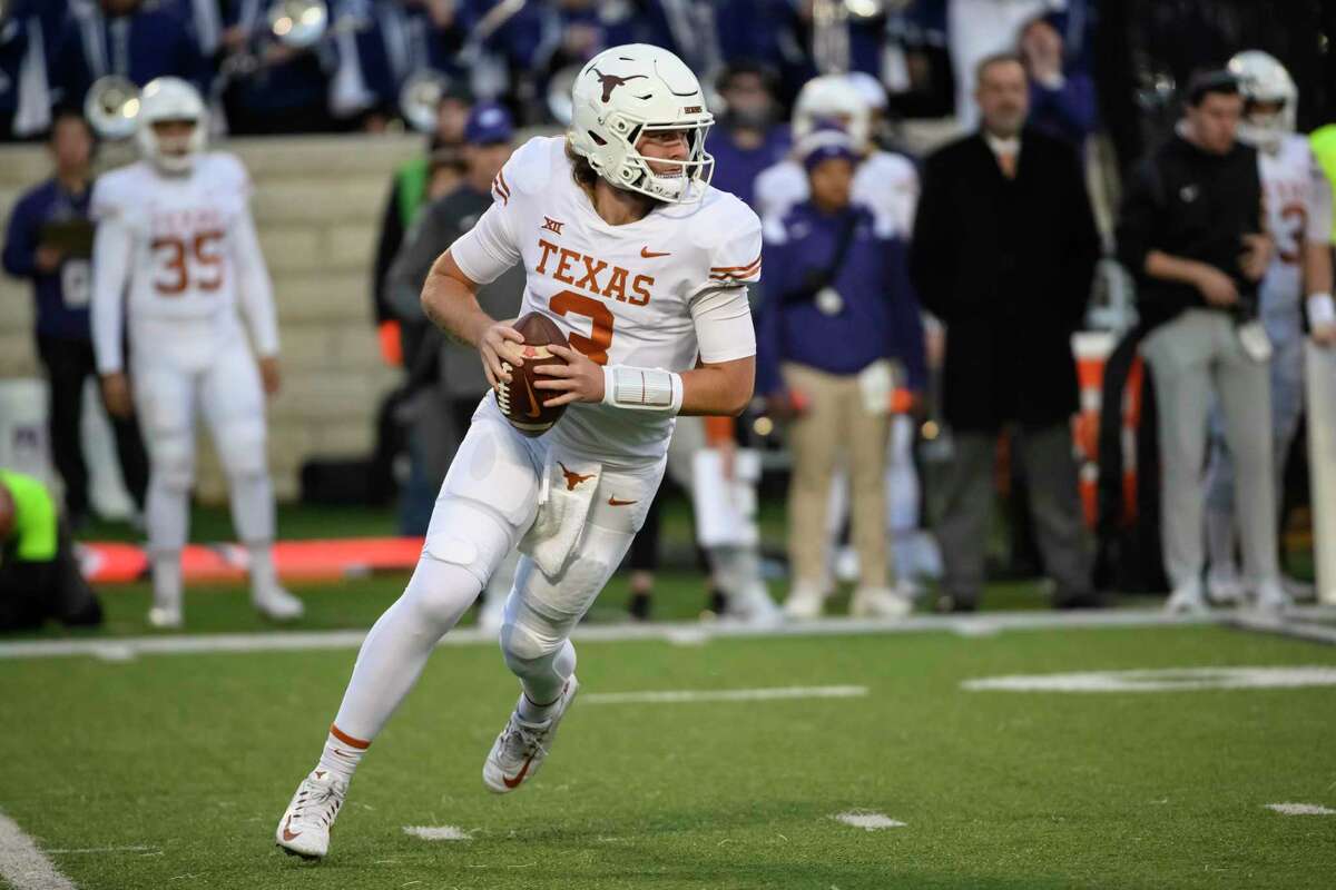 Texas quarterback Quinn Ewers (3) rolls out to throw against Kansas State during the first half of an NCAA college football game Saturday, Nov. 5, 2022, in Manhattan, Kan. (AP Photo/Reed Hoffmann)
