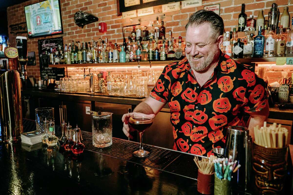 Bartender Ruari Horan makes a drink at Pitt's Pub.