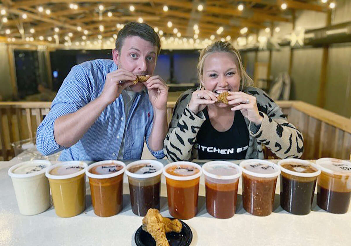 Ryne Turke (left), host of the Hot Ones Chicken Wing Challenge, and Rachel Rohn, co-owner of K’s Creek Golf Club and Kitchen 63 in Jacksonville, test the sauces ahead of the 2021 challenge. The charity event, which is Saturday, will feature Jacksonville residents eating increasingly hot chicken wings in a bid to raise money for area charities.