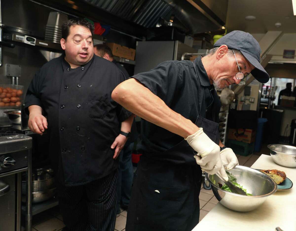 Head chef trainer Joey Bronk (left) from Farming Hope watches as Ronnie makes a salad as they do a breakfast pop up at Manny's on Tuesday, June 18, 2019 in San Francisco, Calif. Ronnie has been homeless with his sister for the past two years and is taking an apprenticeship with Farming Hope, a non-profit providing transitional employment and training in the culinary industry to low income and homeless.