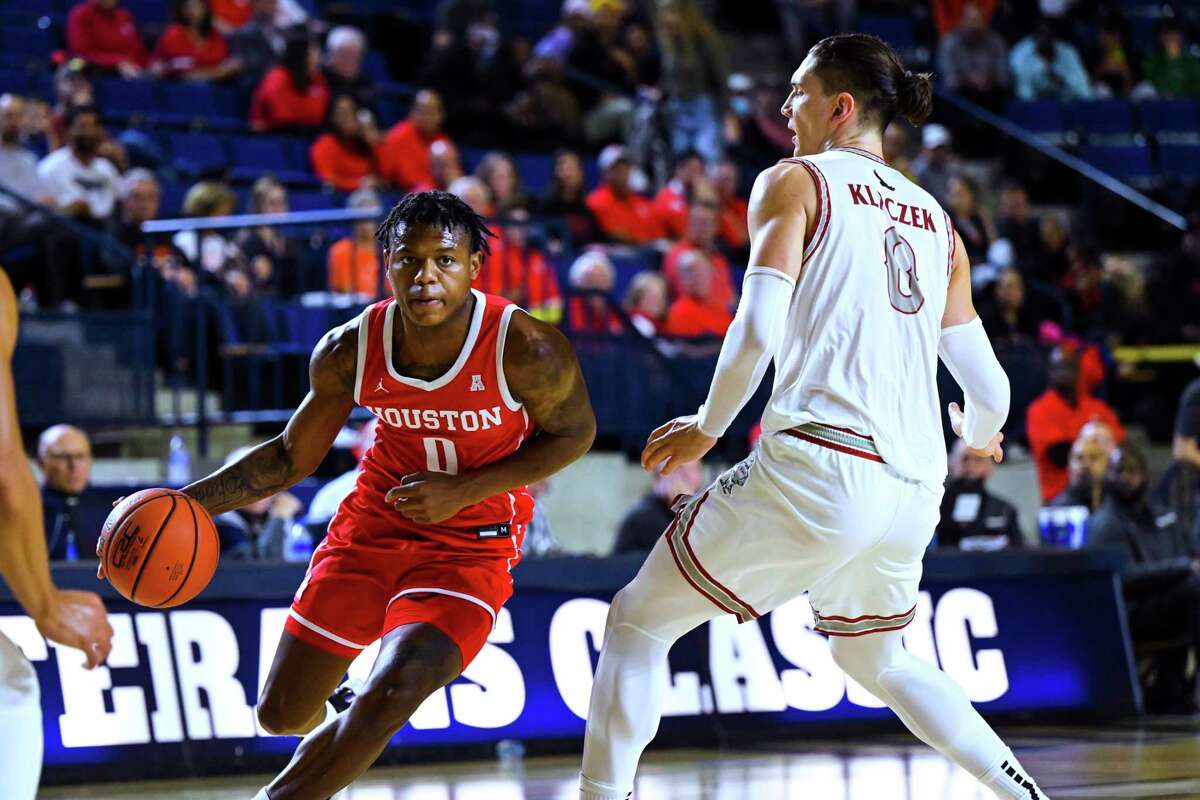 Houston guard Marcus Sasser drives against Saint Joseph's forward Kacper Klaczek during the first half of an NCAA college basketball game at the Veterans Classic, Friday, Nov. 11, 2022, in Annapolis, Md. (AP Photo/Terrance Williams)
