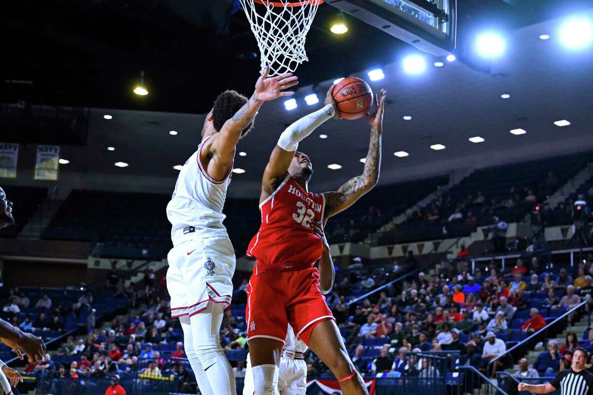Houston forward Reggie Chaney (32) is fouled by Saint Joseph's guard Cameron Brown, rear, during the first half of an NCAA college basketball game at the Veterans Classic, Friday, Nov. 11, 2022, in Annapolis, Md. (AP Photo/Terrance Williams)