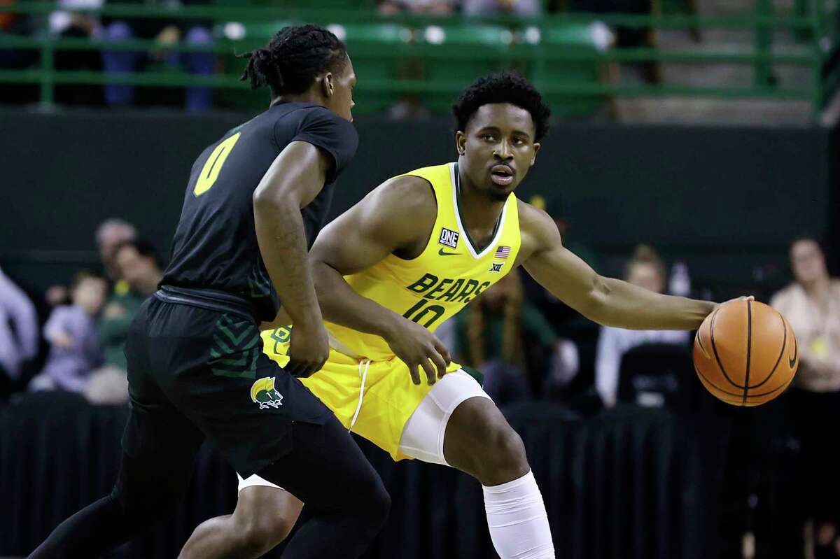 Baylor guard Adam Flagler drives the ball up court against Norfolk State guard Christian Ings in the first half of an NCAA college basketball game, Friday, Nov. 11, 2022, in Waco, Texas.