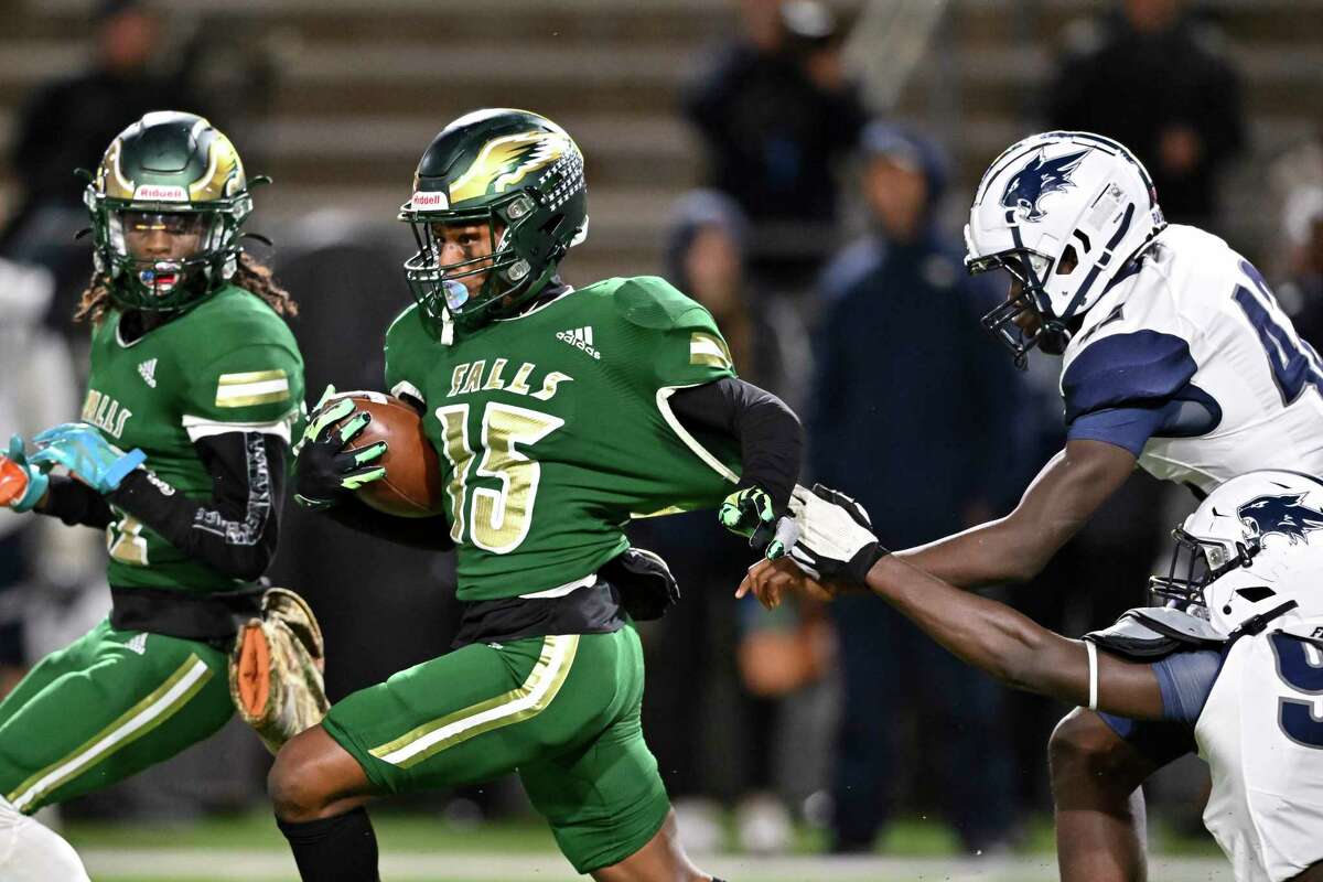 Cypress Falls defensive back Meeky Hosea (15) breaks the tackle from Tomball Memorial defensive linemen Andrew Nsiah (92) during the first quarter of the Region II-6A Division II bi-district game at Ken Pridgeon Stadium in Houston, Friday, Nov. 11, 2022.