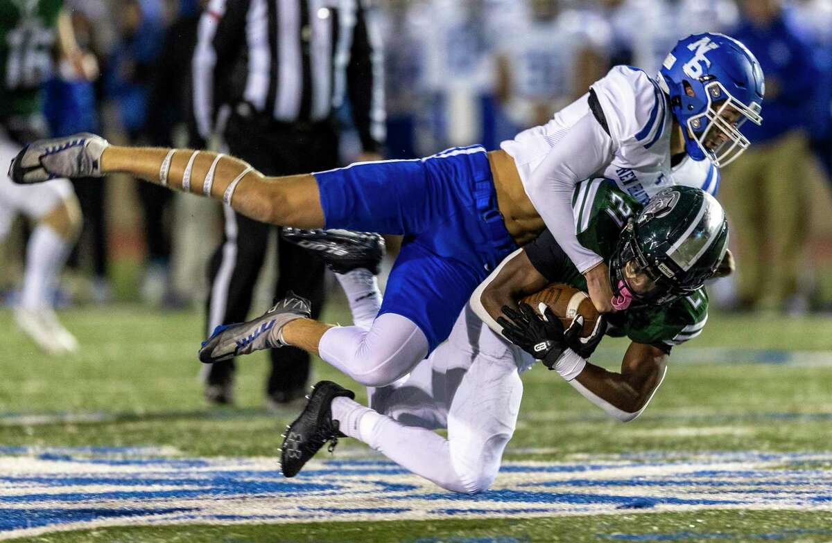 Reagan running back Cole Pryor is tackled Friday night, Nov. 11, 2022 at Commander Stadium by New Braunfels’ defensive back Landon Jones during the first half of the Rattlers’ game against the Unicorns.
