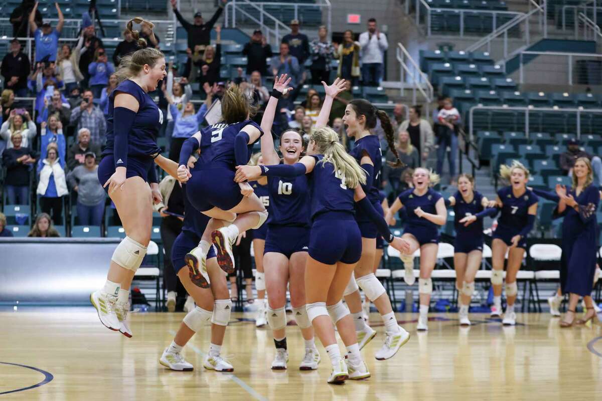 The Lake Creek Lions celebrate after winning their Region III-5A volleyball championship match between the Lake Creek Lions and the Brenham Cubettes at Merrell Center in Katy, TX on Saturday, November 12, 2022.