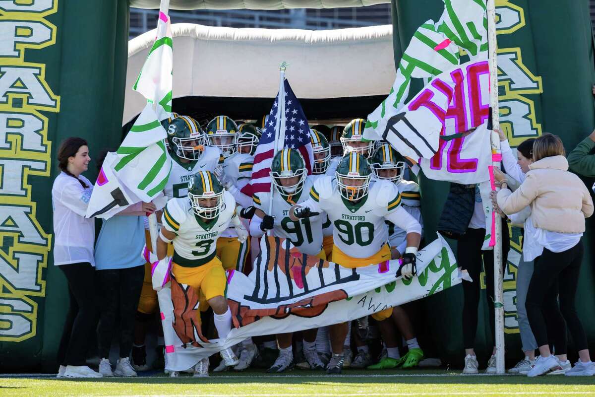 Stratford players Derrik Cadavid (3), Austini LaRue (91), and Hunter Jones (90) lead their team out onto the field before a Region III-6A Division II bi-district game high school football game between Heights and Stratford Saturday, Nov 12, 2022, in Houston.