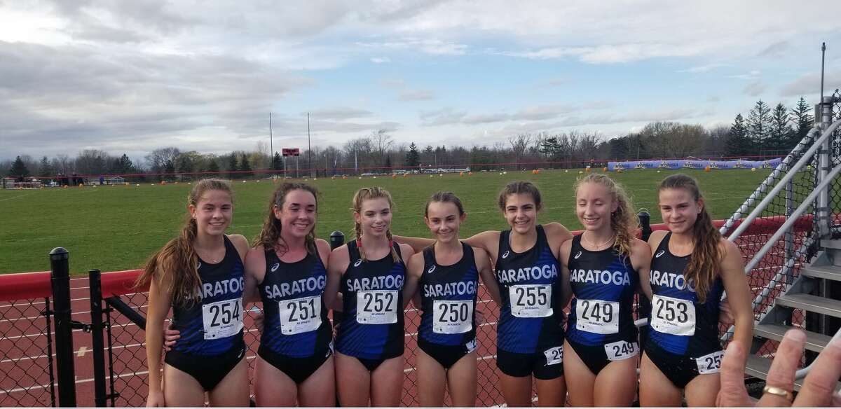 McKinley Wheeler, right, poses with her teammates after winning the state meet on Saturday, Nov. 12, 2022. Wheeler finished second in the Nike New York/New England regional meet.