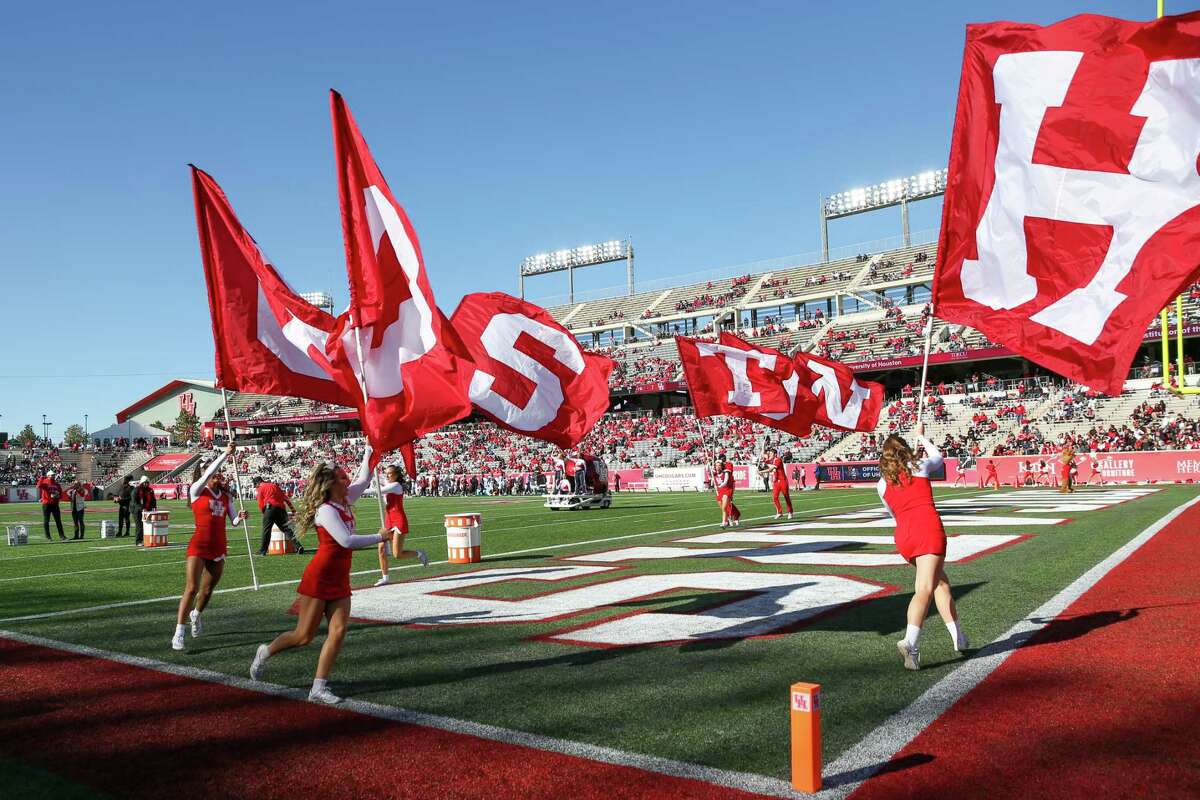 HOUSTON, TX NOV 12: Houston Cougars cheer squad runs team flags after a scored touchdown in the second quarter during the college football game between the Temple Owls and Houston Cougars at TDECU Stadium in Houston, Texas.