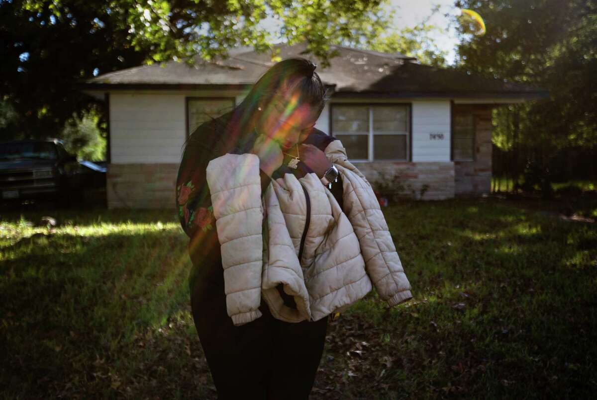 Desiree Stewart holds her son’s jacket as she stands for a portrait at her parents’ home, Saturday, Nov. 12, 2022, in Houston. Stewart's son, 17-year-old Robert “FYN Duke” Butler, died in March 2022 in a shooting at a birthday party.