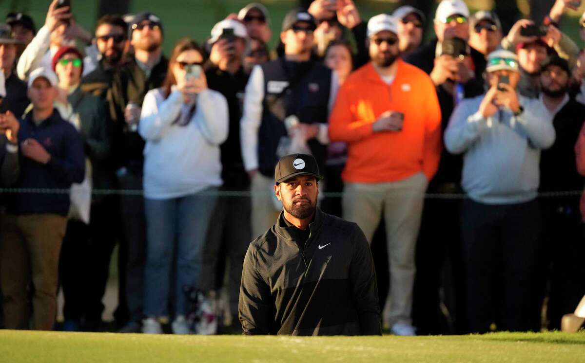 Tony Finau watches his bunker shot on the 18th hole during the third round of the Houston Open golf tournament, Saturday, Nov. 12, 2022, in Houston.