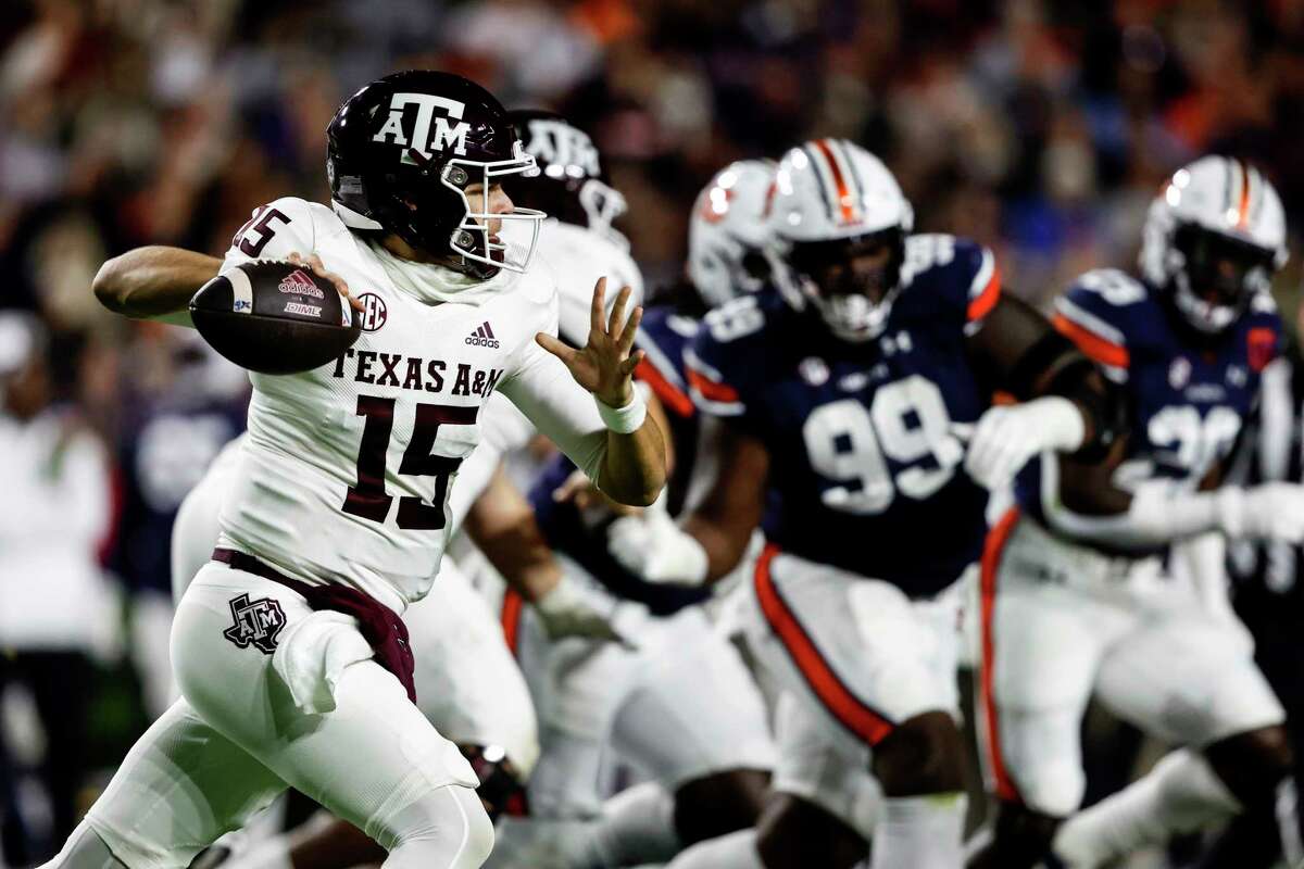 Texas A&M quarterback Conner Weigman (15) rolls out to pass against Auburn during the first half of an NCAA college football game, Saturday, Nov. 12, 2022, in Auburn, Ala. (AP Photo/Butch Dill)