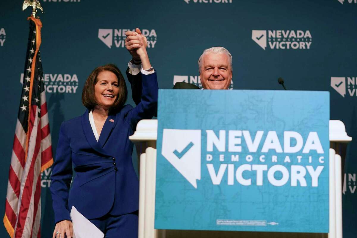 Sen. Catherine Cortez Masto, D-Nev., left, reacts alongside Nevada Gov. Steve Sisolak during an election night party hosted by the Nevada Democratic Party, Tuesday, Nov. 8, 2022, in Las Vegas.