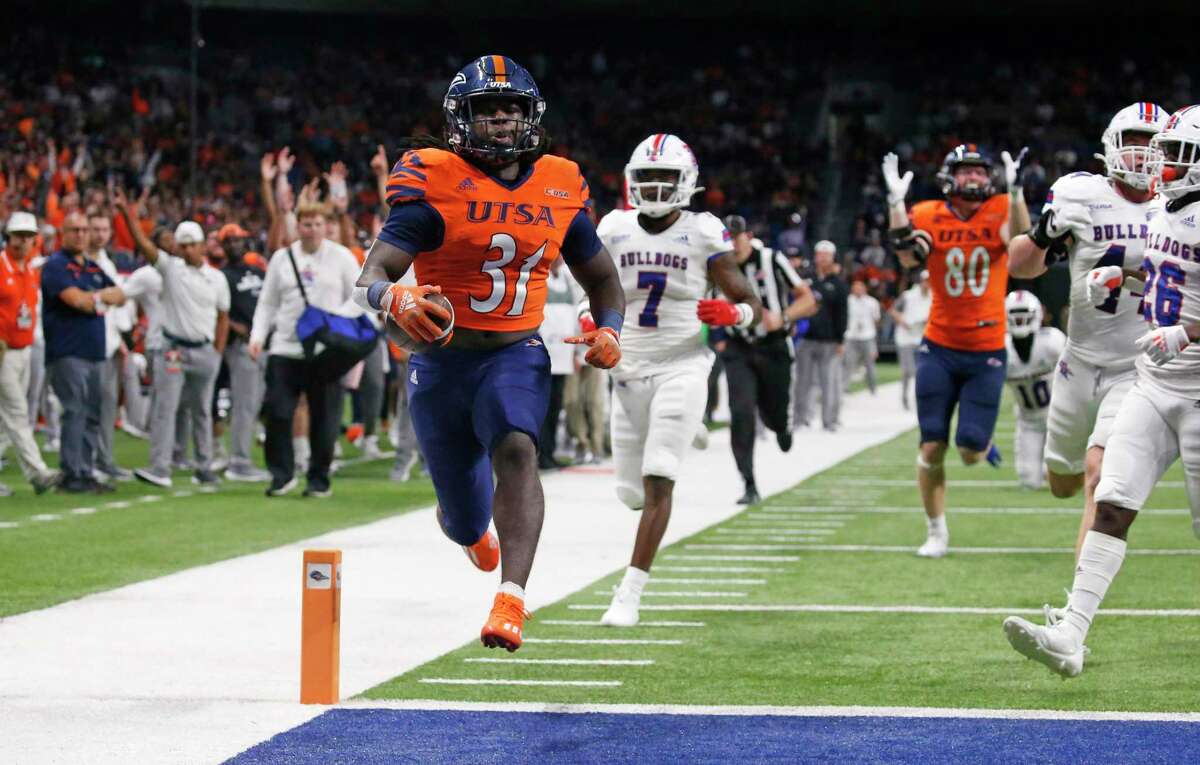 UTSA’s Kevorian Barnes cruises into the end zone for a touchdown as he leaves Louisiana Tech’s Khiry Morrison behind during the first half of Saturday’s game at the Alamodome.