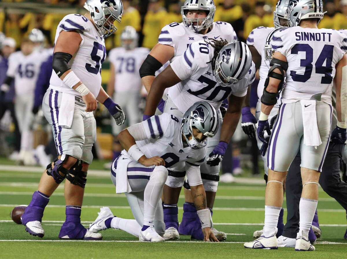 Kansas State quarterback Adrian Martinez (9) is looked over by Kansas State offensive lineman KT Leveston (70) after getting injured on a play against Baylor in the first half of an NCAA college football game, Saturday, Nov.12, 2022, in Waco, Texas. (Rod Aydelotte/Waco Tribune-Herald via AP)