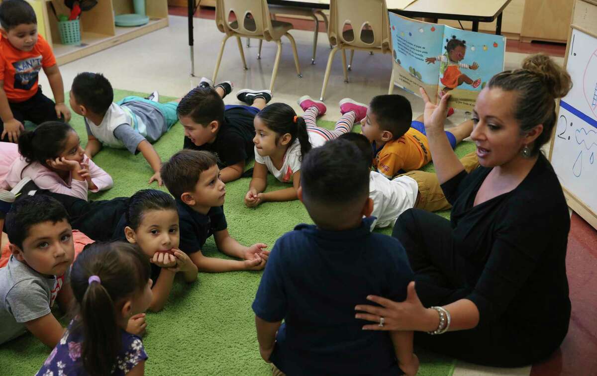 Dual language teacher Elizabeth Rendon reads to her class at Tynan Early Childhood Education Center in 2019. The school might lose its operating partnership with the nonprofit High Scope under a proposal now before SAISD trustees.