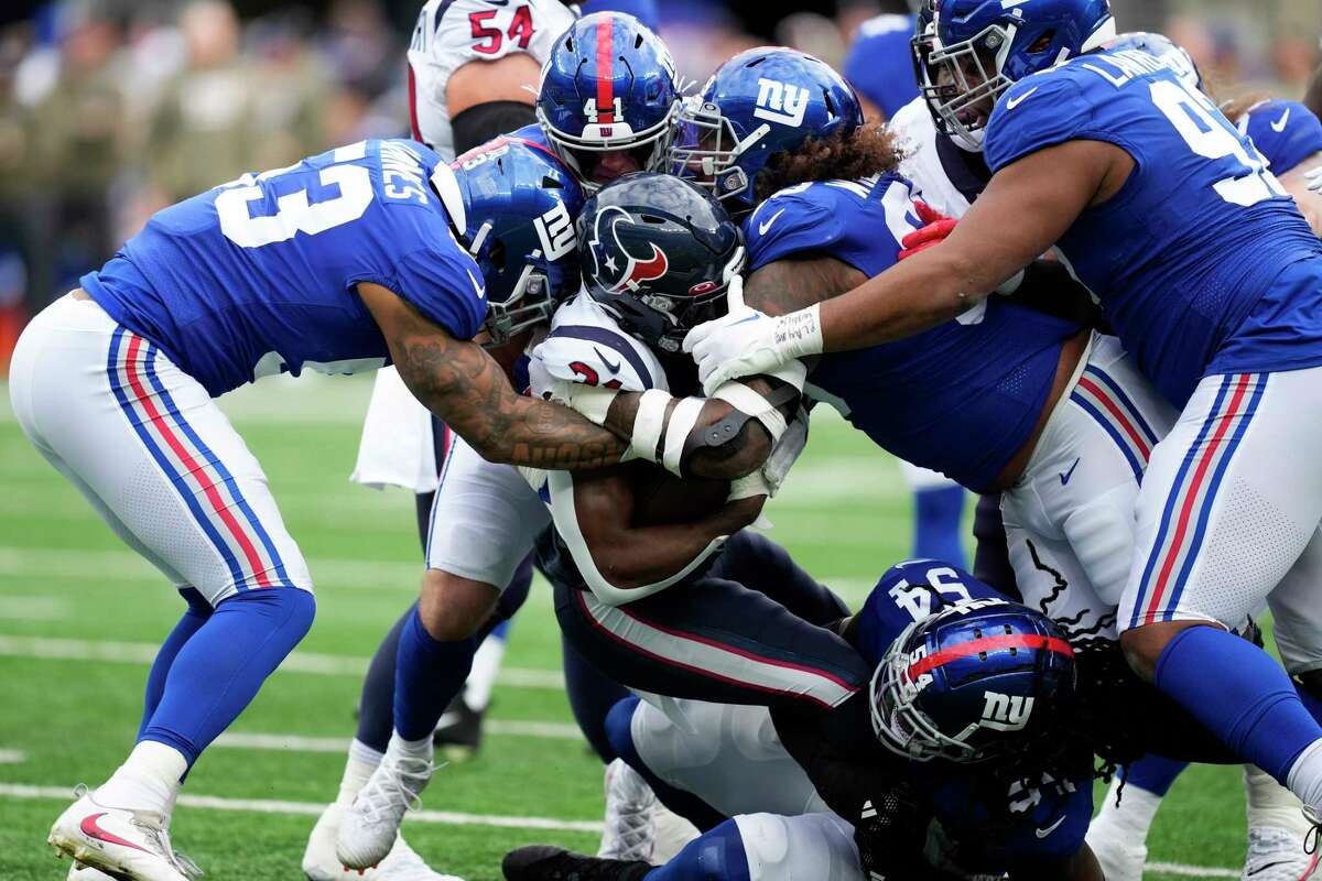 Houston Texans running back Dameon Pierce (31) is stopped by a host of New York Giants defenders during the first quarter of an NFL football game Sunday, Nov. 13, 2022, in East Rutherford, N.J.