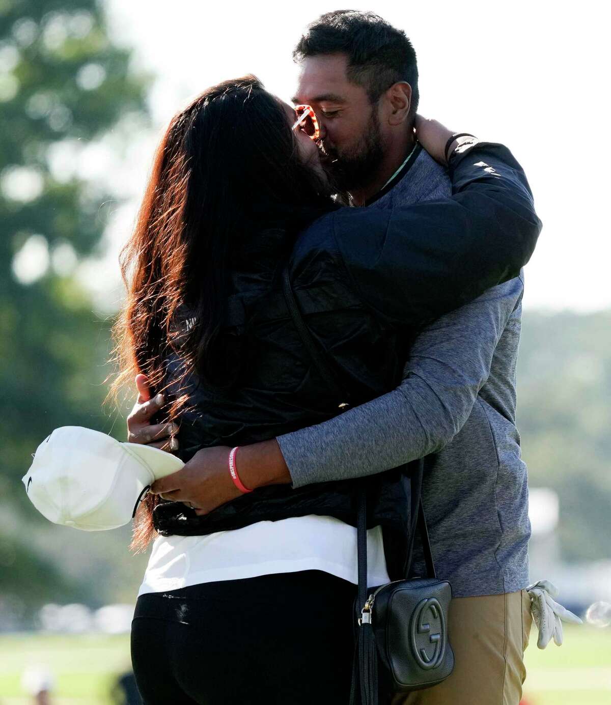 Tony Finau, right, celebrates his win of the Houston Open golf tournament with wife, Alayna, Sunday, Nov. 13, 2022, in Houston.