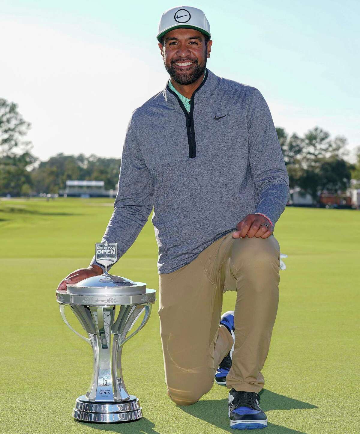 Tony Finau poses with the champions’ trophy after winning the Houston Open golf tournament, Sunday, Nov. 13, 2022, in Houston.