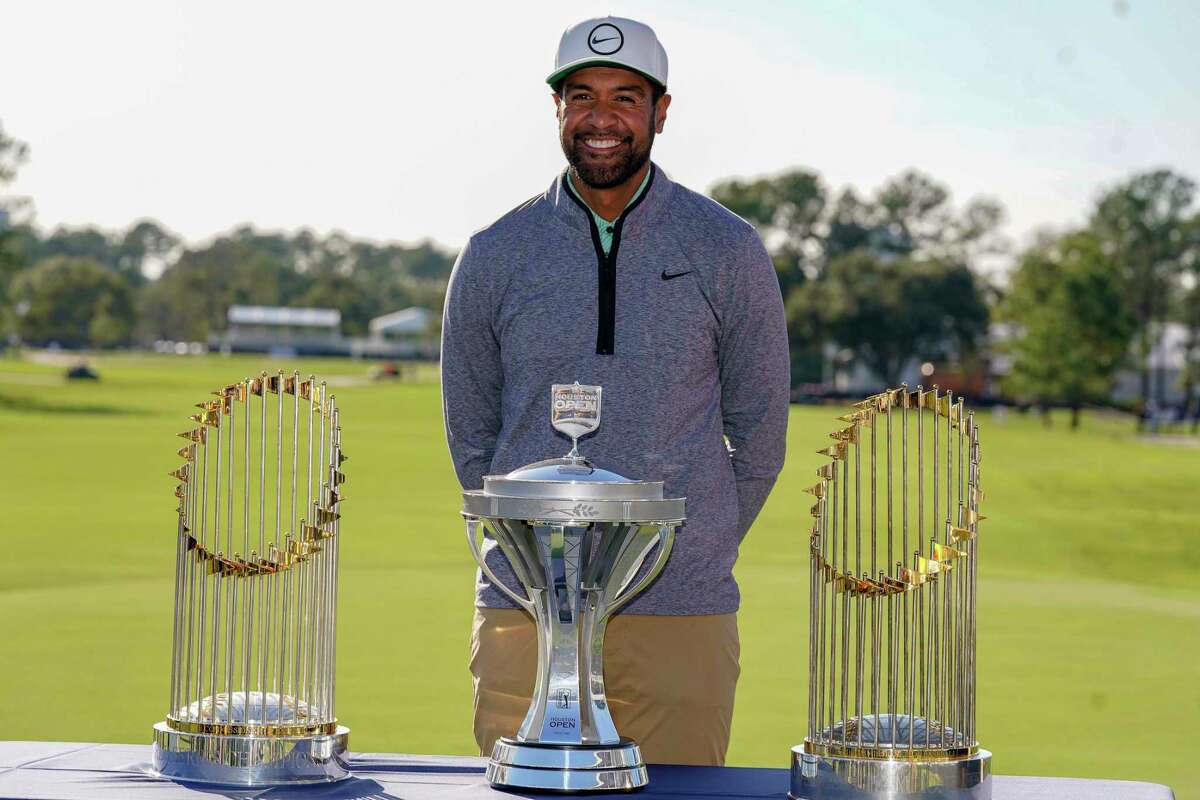 Tony Finau poses with the champions’ trophy and the Houston Astros’ two commissioner’s trophies after winning the Houston Open golf tournament, Sunday, Nov. 13, 2022, in Houston.