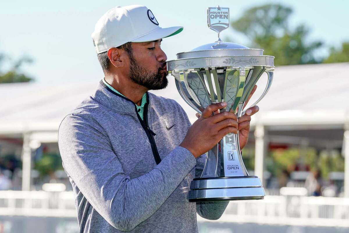 Tony Finau kisses the champions’ trophy after winning the Houston Open golf tournament, Sunday, Nov. 13, 2022, in Houston.