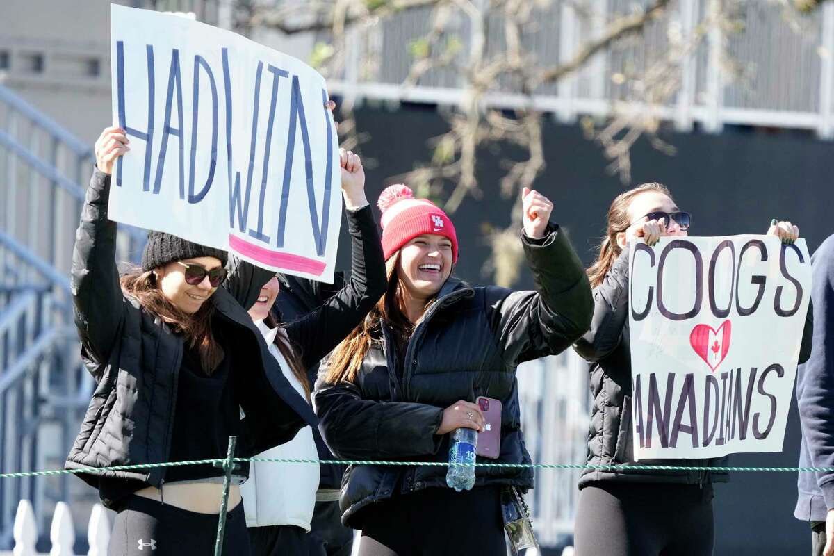 Fans of PGA golfer Adam Hadwin hold signs during the final round of the Houston Open golf tournament, Sunday, Nov. 13, 2022, in Houston.