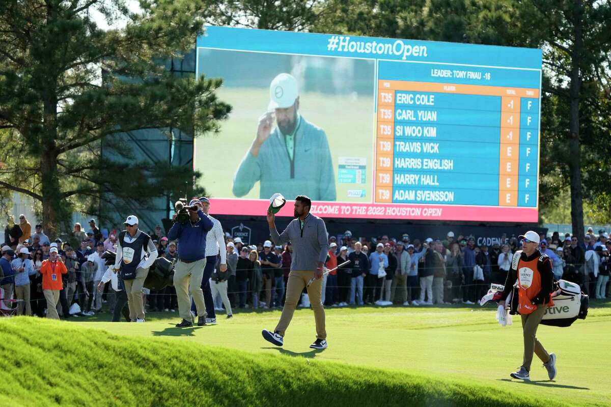 Tony Finau acknowledges the gallery as he walks to the 18th green during the final round of the Houston Open golf tournament, Sunday, Nov. 13, 2022, in Houston.