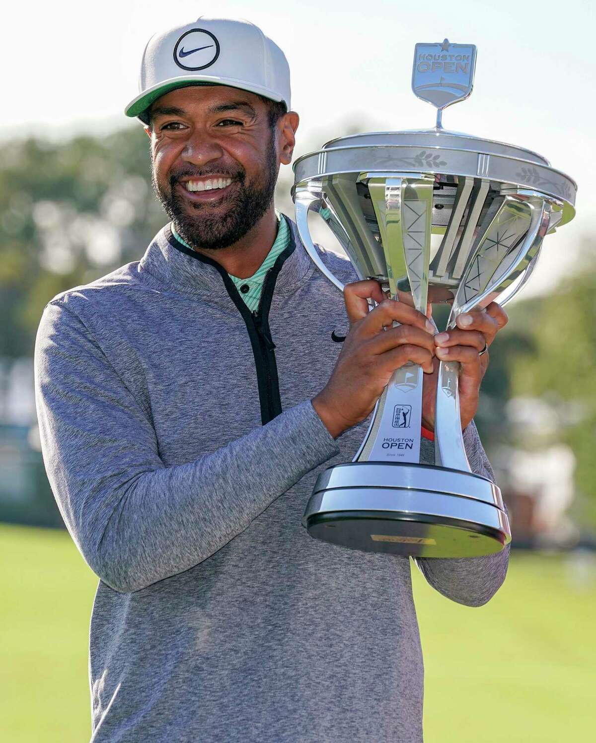 Tony Finau holds the champions’ trophy after winning the Houston Open golf tournament, Sunday, Nov. 13, 2022, in Houston.
