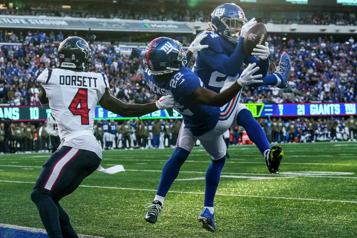New York Giants safety Dane Belton (24) hauls in an interception of a pass in the end zone intended for Houston Texans wide receiver Phillip Dorsett (4) during the fourth quarter of an NFL football game Sunday, Nov. 13, 2022, in East Rutherford, N.J.