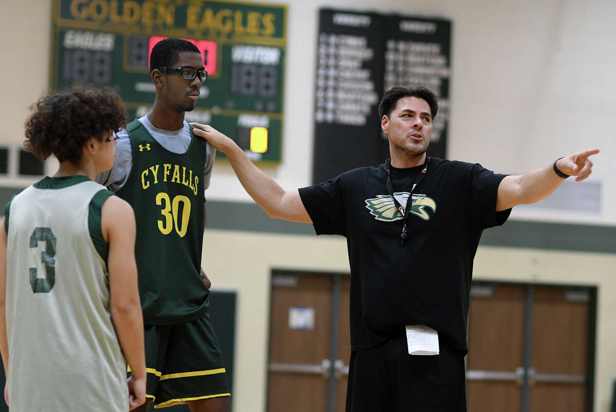 Cy-Falls Boys Head Basketball Coach Richard Flores shares a teaching moment with Brayden Young (30) during team practice at Cy-Falls High School on Nov. 11, 2022.