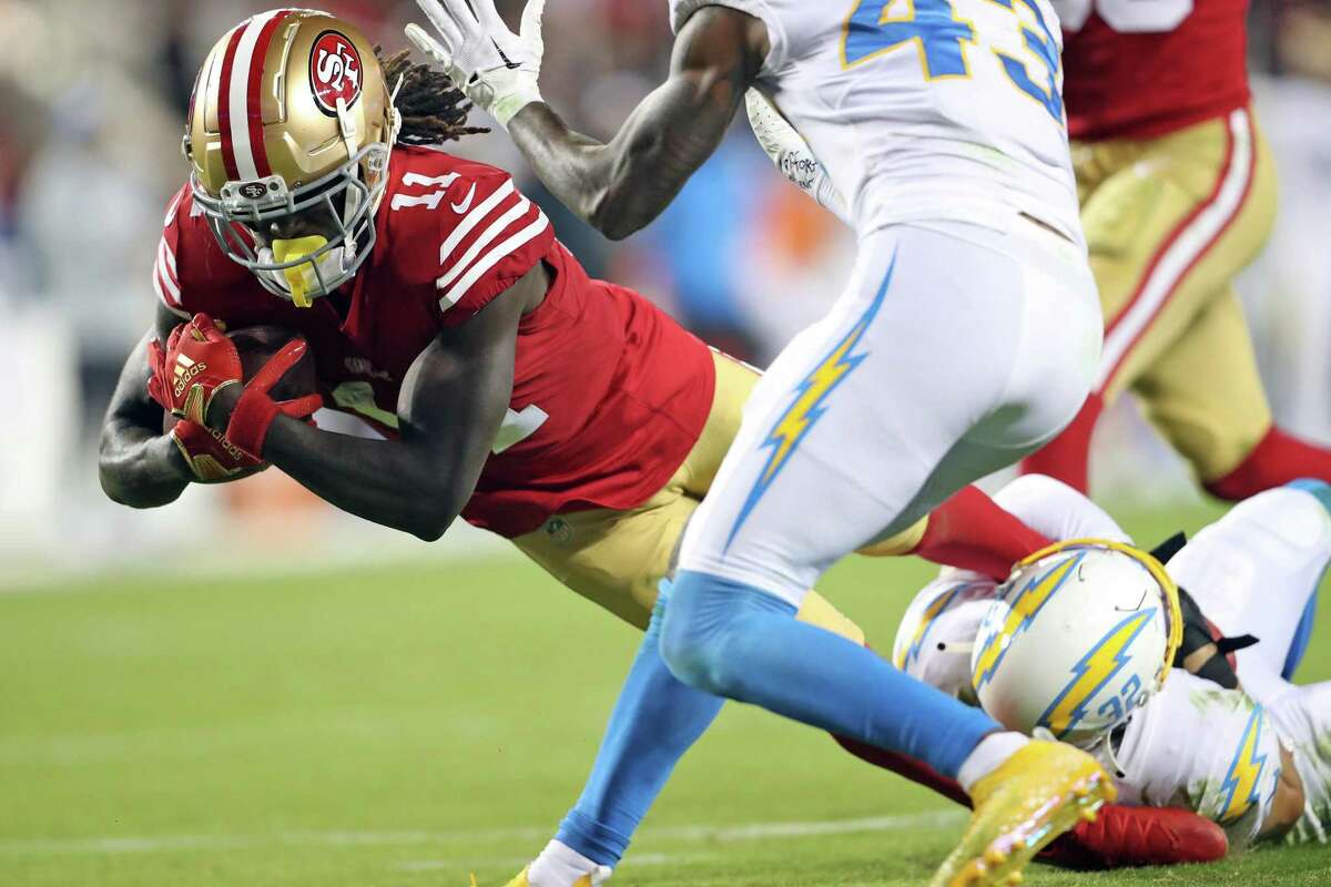 San Francisco 49ers’ Brandon Aiyuk dives for yardage after a 4th quarter coach against Los Angeles Chargers during Niners’ 22-16 win in NFL game at Levi’s Stadium in Santa Clara, Calif., on Sunday, November 13, 2022.