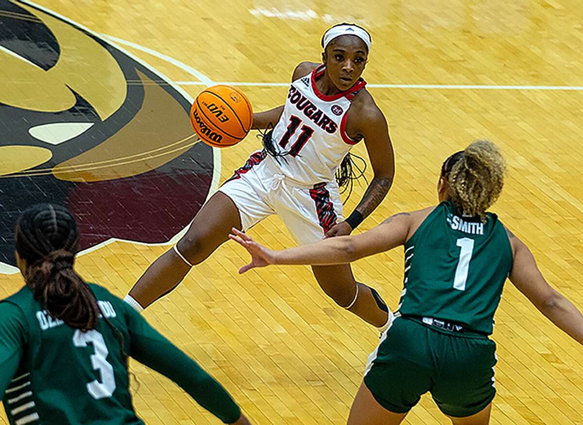SIUE's Niya Danfort (11) handles the ball against Eastern Michigan on Sunday afternoon at First Community Arena in Edwardsville. Danfort led the Cougars with 16 points in the loss.