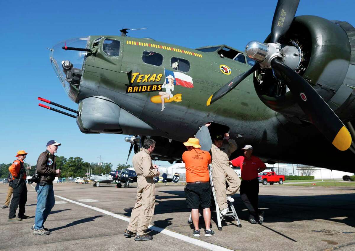 Guests tour three locally-based aircraft, including a B-17 Flying Fortress, "Texas Raiders," during a trip to General Aviation Services, Saturday, Nov. 6, 2021, in Conroe, Texas. The Commemorative Air Force Gulf Coast Wing identified a B-17 that crashed in Dallas on Saturday, Nov. 12, 2022, as Conroe-based "Texas Raiders." 