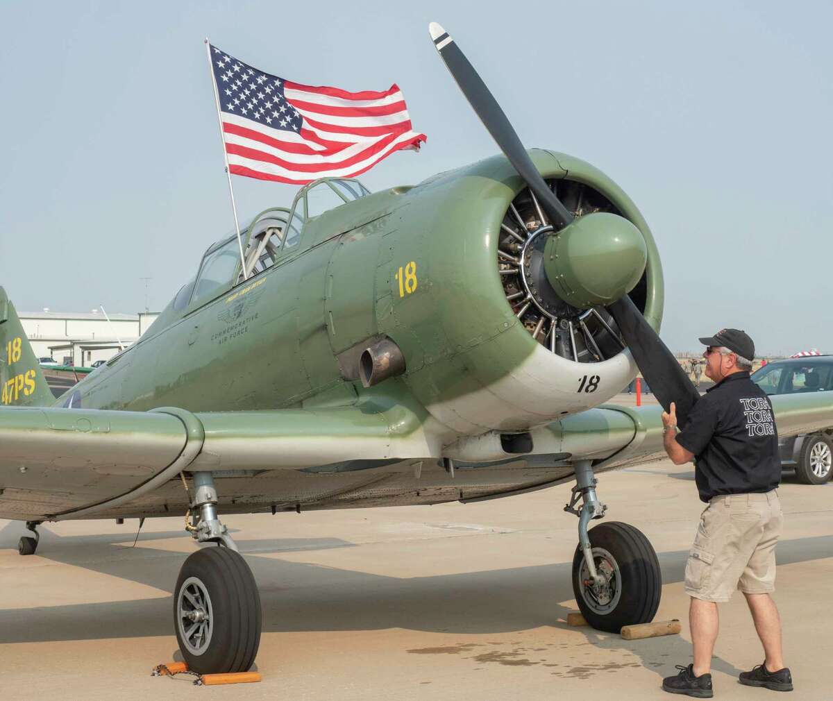 Craig Hutain, Tora 18 Hawk, from Montgomery, TX, rotates the propeller of his T-6 to clear oil in the bottom cylinders as he readies his plane 09/11/2021 before the start of the flying at Midland International Air and Space Port. Tim Fischer/Reporter-Telegram
