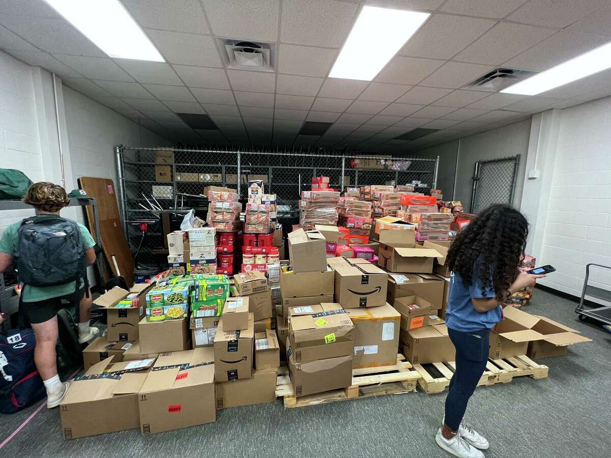 Donated goods are stacked and waiting to be sorted as part of a weeklong food drive benefiting food banks in the Spring Branch ISD area.