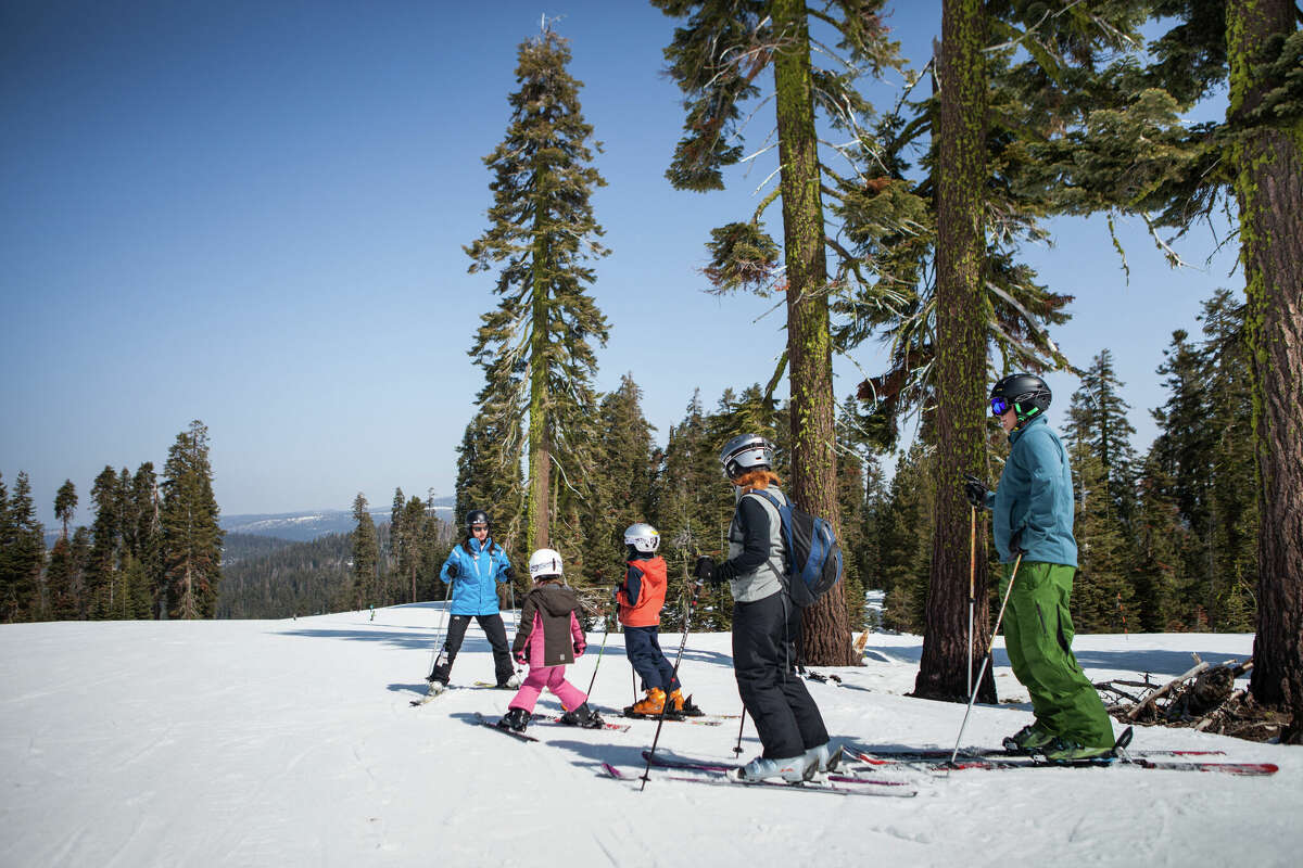 A family of skiers gets ready to check out Badger Pass' runs. An adult season pass is about the same price as two weekend days at Tahoe resorts. 