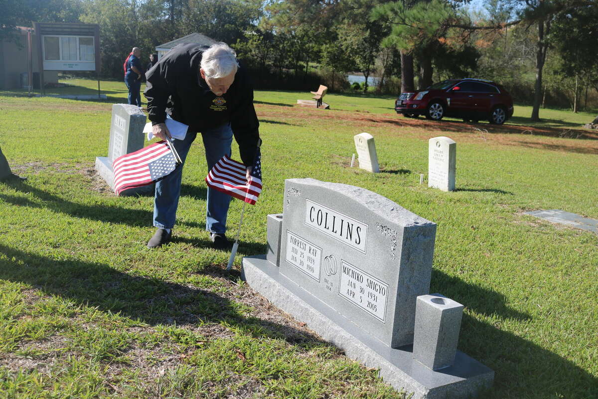 Post 521 member Bill Schiemann plants an American flag at one of the 18 gravesites of veterans at Crown Cemetery in Pasadena.