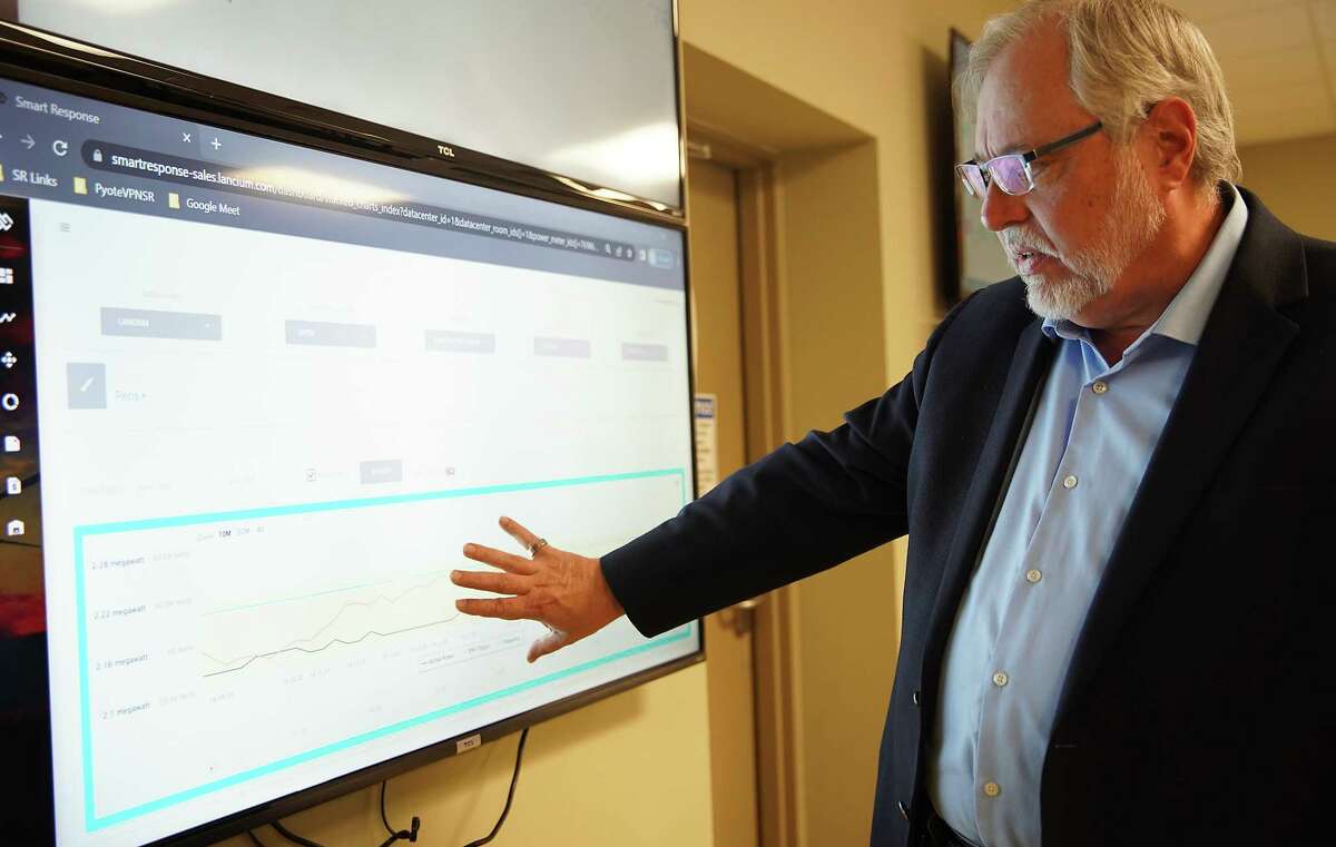 Raymond Cline Jr., CTO and co-founder of Lancium, explains the monitor system the company uses on Monday in Houston. The Houston-based company will launch its platform this week that will allow bitcoin mining operations and data center to ramp down their power usage automatically to respond to tight grid conditions