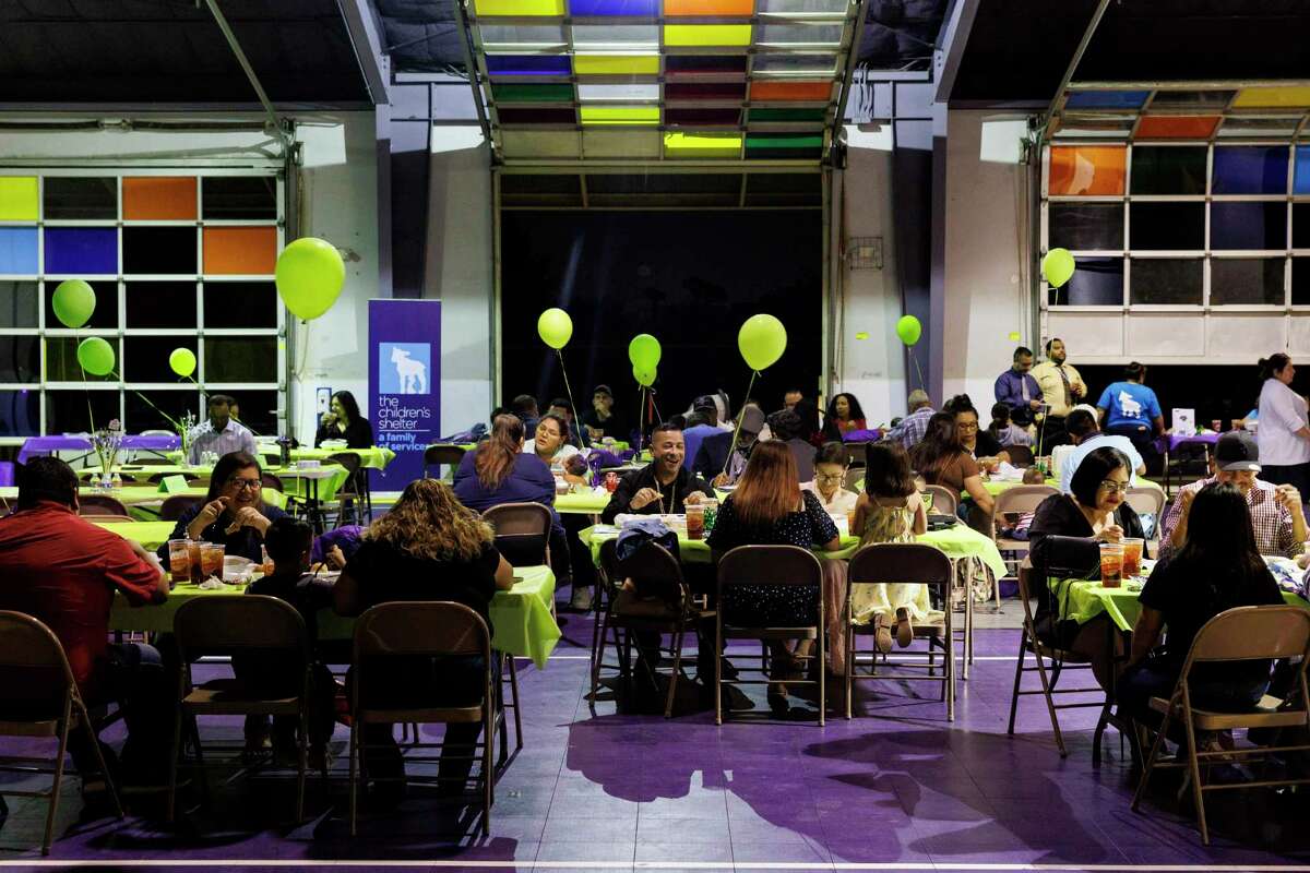 People share a meal together during the 64th commencement ceremony for fathers enrolled in the Compadre y Compadre program at The Children’s Shelter in San Antonio on Thursday. The 15-week course emphasizes strengthening the male caregiver’s role with their children and family.