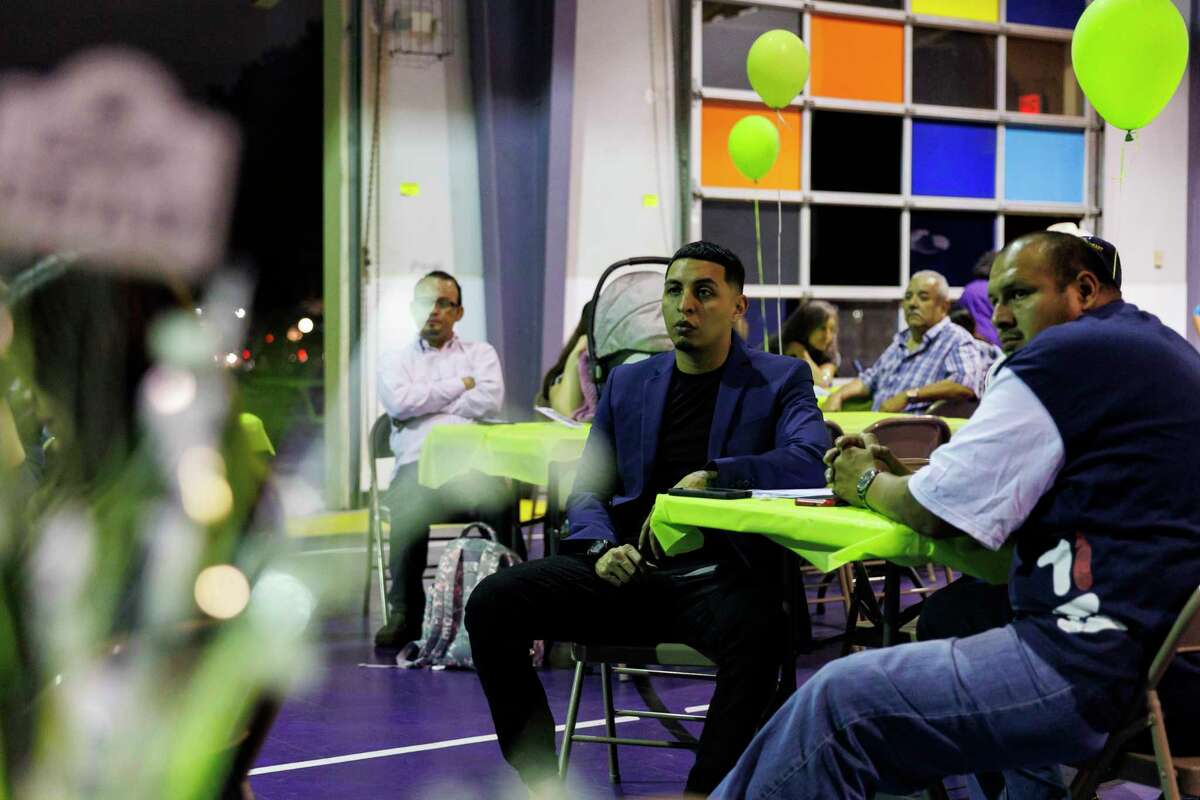 Rafael De La Cerda, center, listens to Marcus Coleman’s speech during the Compadre y Compadre program’s 64th commencement ceremony at The Children’s Shelter in San Antonio on Thursday. Cerda and other fathers graduated from the 15-week course, which emphasizes strengthening the male caregiver’s role with their children and family.